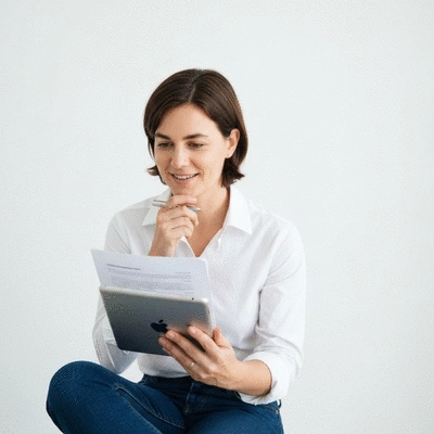 Person reviewing health insurance documents on a tablet, with a friendly and thoughtful expression, clean image